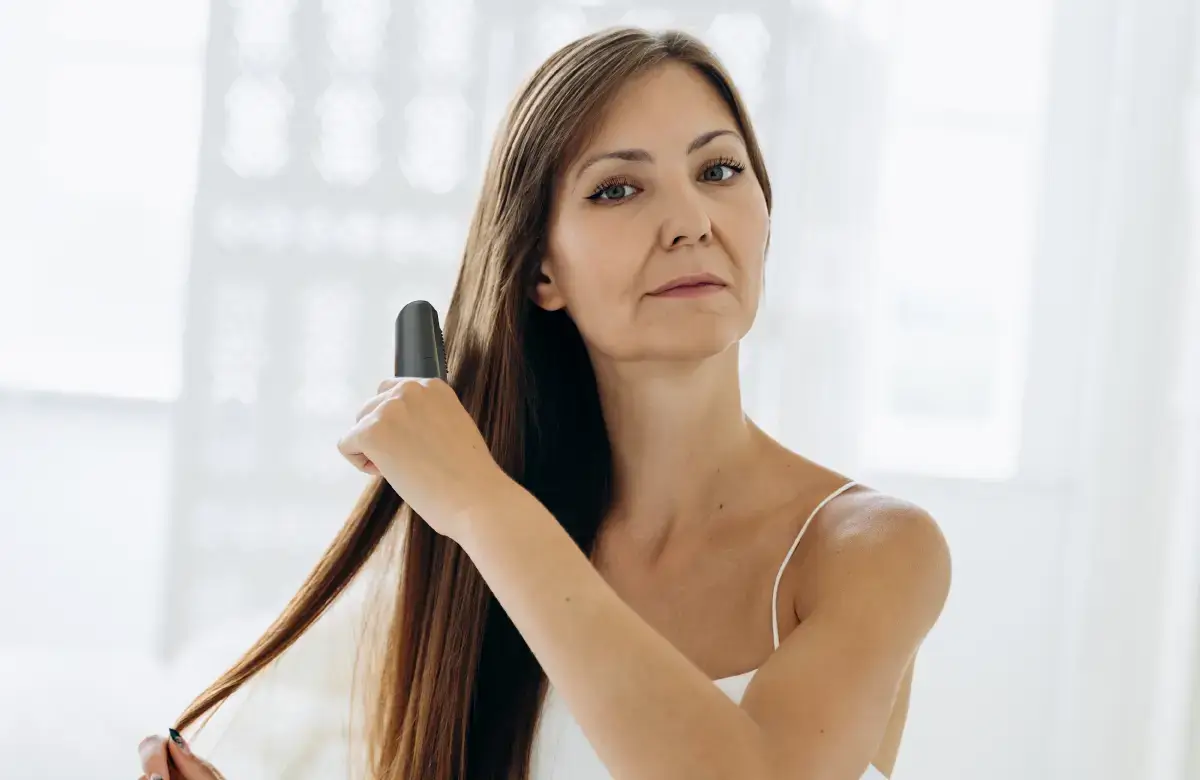 woman straightening her hair